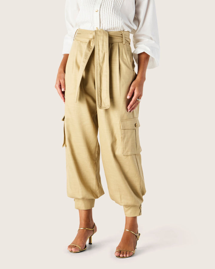 Beige cargo pants worn by a person on a white background